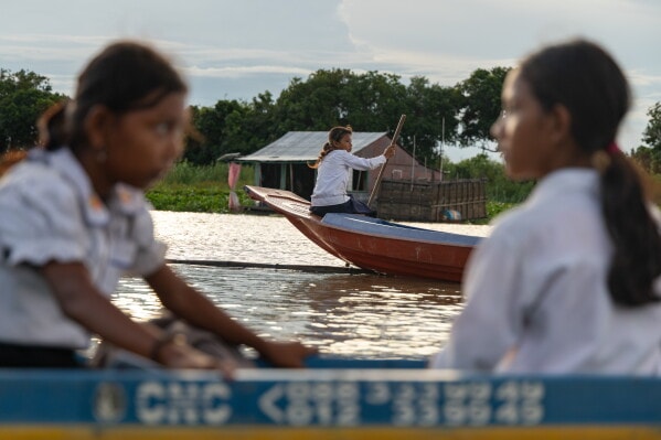 Pics - Cambodian kids take boats to school as war sends fuel costs soaring
